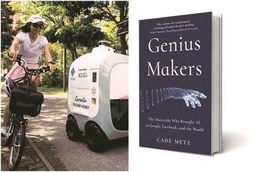 A cyclist passes an autonomous grocery delivery robot in Singapore earlier this month (Reuters image)