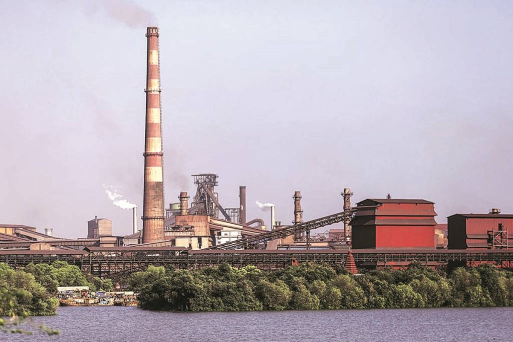 Smoke and steam rise from the JSW Steel Ltd. manufacturing facility in Dolvi, Maharashtra, India, on Thursday, May 18, 2017. JSW, India's biggest producer, reported a jump in fourth-quarter profit, boosted by record output, and said it approved plans to raise about $2.5 billion in debt. Photographer: Dhiraj Singh/Bloomberg
