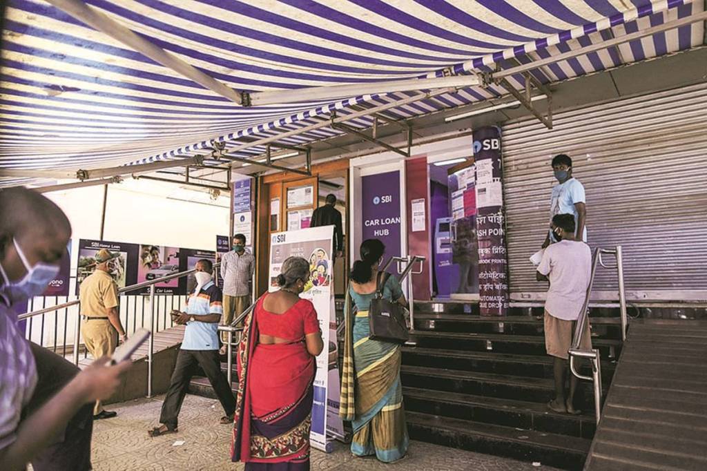 Customers wait in line at a State Bank of India (SBI) branch in Mumbai, India, on Monday, May 4, 2020. India's central bank Governor Shaktikanta Das and the chief executive officers of the nation's banks have discussed ways to ensure credit flow to businesses once the world's toughest stay-at-home order ends. Photographer: Dhiraj Singh/Bloomberg