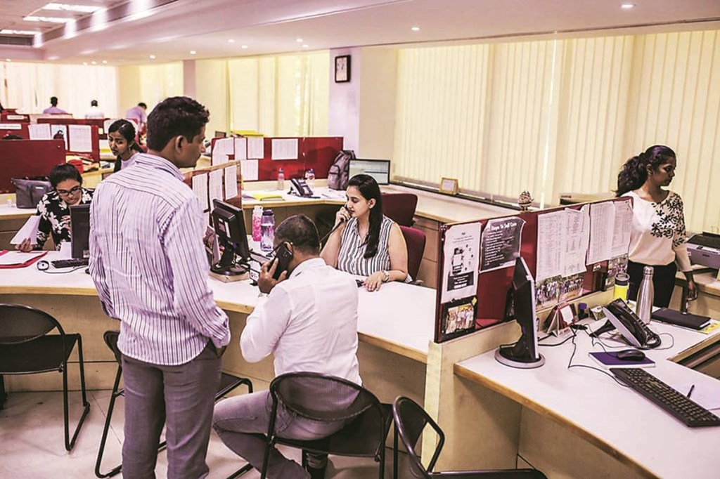An employee attends to customers at a Housing Development Finance Corp. (HDFC) bank branch in Mumbai, India, on Monday, June 3, 2019. The Reserve Bank of India rate decision is scheduled for June 6. Photographer: Dhiraj Singh/Bloomberg