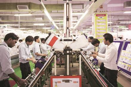 Workers assemble wire harnesses at the Motherson Sumi Systems Ltd. wiring harness plant in Faridabad, India, on Thursday, Feb. 28, 2013. Motherson Sumi Systems Ltd., 25 percent owned by Sumitomo Electric Industries Ltd. and India's biggest auto parts maker, supplies rear view mirrors, bumpers and body panels to clients including Porsche Automobil Holding SE, Bayerische Motoren Werke AG and Volkswagen AG. Photographer: Brent Lewin/Bloomberg