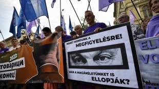 A man holds Hungary's PM Viktor Orban’s poster during a protest against the Hungarian government for using Pegasus spyware to monitor journalists, opposition leaders and activists in Budapest, Hungary (Reuters photo)