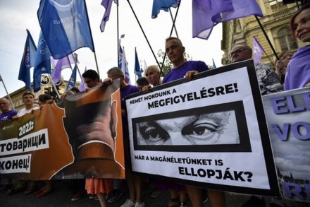 A man holds Hungary's PM Viktor Orban’s poster during a protest against the Hungarian government for using Pegasus spyware to monitor journalists, opposition leaders and activists in Budapest, Hungary (Reuters photo)