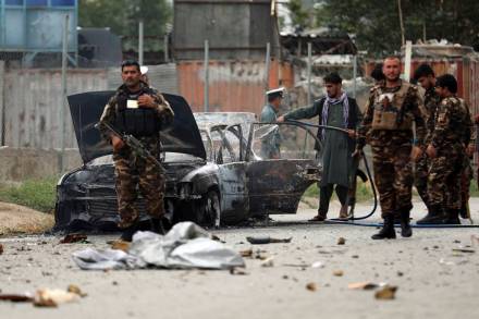 Security personnel inspect a damaged vehicle which was firing rockets in Kabul, Afghanistan. At least three rockets hit near the presidential palace on Tuesday shortly before Afghan President Ashraf Ghani was to give an address to mark the Muslim holiday of Eid-a-Adha. (AP Photo)