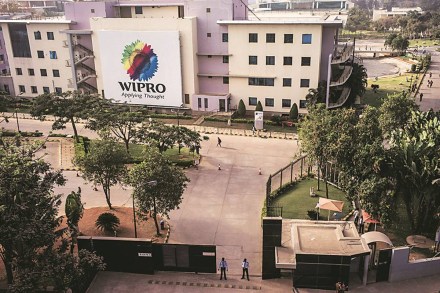 The Wipro Ltd. logo is displayed on the side of the company's offices in Bangalore, India, on Monday, Feb. 4, 2013. Wipro forecast information-technology services revenue in the range of $1.59 billion and $1.63 billion in the quarter through March. Photographer: Sanjit Das/Bloomberg