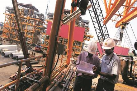 Larsen & Toubro Ltd. engineers supervise work at a booster compressor process module, part of an offshore oil drilling platform, in Hajira, India, on Tuesday, Oct. 9, 2007. Larsen & Toubro Ltd., India's biggest engineering company, will build ships for the navy and companies at a proposed 20 billion rupee ($506 million) shipyard, expanding the marine business to tap rising demand for sea transport. Photographer: Prashanth Vishwanathan/Bloomberg News