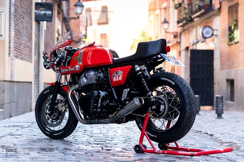 The exhaust headers have been shortened and now exhale through a pair of Turbokit megaphones. Elsewhere, Pepo’s added LED turn signals, a custom license plate support, and a CNC-machined chain tensioner and sprocket cover from Riga Billet Parts. Artenruta handled the cheeky red livery—the perfect finishing touch for this rapid-looking Royal Enfield. (Bikeexif)