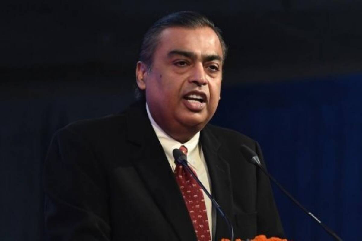 Mukesh Ambani, chairman and managing director of the Reliance Industries Ltd., right, and his wife Nita Ambani, left, arrive for the company's annual general meeting in Mumbai,