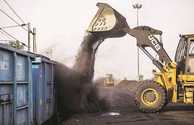 A JC Bamford Excavators Ltd. (JCB) front loader loads coal onto a freight wagon at the Tori Siding on the Tori-Shivpur rail line, operated by Indian Railways and funded by Coal India Ltd., in Chandwa, Jharkhand, India, on Thursday, May 17, 2018. State miner Coal India's output and shipments jumped to seasonal records in June, buoyed by summer demand from power stations, the company's biggest customers. Photographer: Prashanth Vishwanathan/Bloomberg