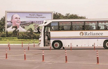 A billboard featuring the Reliance Industries Ltd. founder Dhirajlal Ambani at an entry gate to the company's oil refinery in Jamnagar, Gujarat, India, on Saturday, July 31, 2021. The Indian city of Jamnagar is a money-making machine for Asia's richest man, Mukesh Ambani, processing crude oil into fuel, plastics and chemicals at the world's biggest oil refining complex that can produce 1.4 million barrels of petroleum a day. Photographer: Dhiraj Singh/Bloomberg