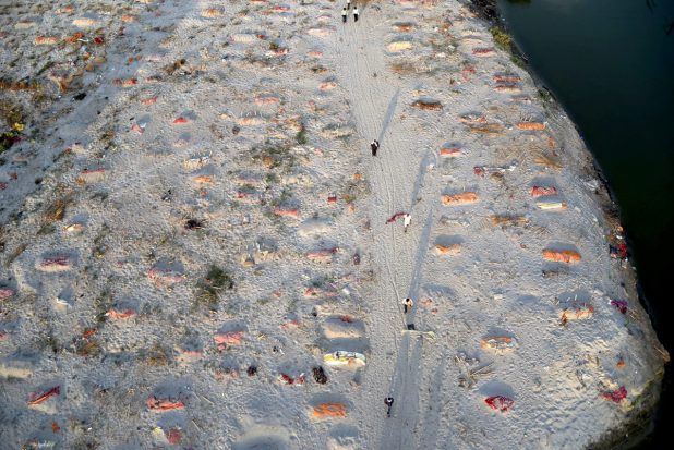 Bodies of the deceased buried under the sand during the second wave of COVID-19 pandemic, near the banks of Ganga river, in Prayagraj on May 15, 2021. (PTI Photo)