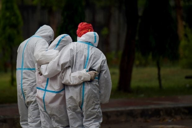Family members react during the cremation of a COVID-19 victim, as coronavirus cases surge in record numbers, at Sarai Kale Khan Crematorium in New Delhi on May 6, 2021. (PTI Photo)