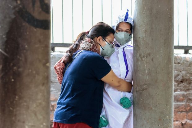 Jailed Pinjra Tod activist Natasha Narwal prepares for the last rites of her father Mahavir Narwal, who died of COVID-19, in Rohtak, Tuesday on May 11, 2021. Natasha, jailed in connection with Delhi riots case, was given interim bail by the Delhi High Court to attend his father's cremation. (PTI Photo)