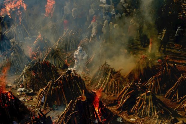 Mass cremation of Covid-19 victims and others takes place at Gazipur Crematorium, in New Delhi on April 26, 2021. (PTI Photo)
