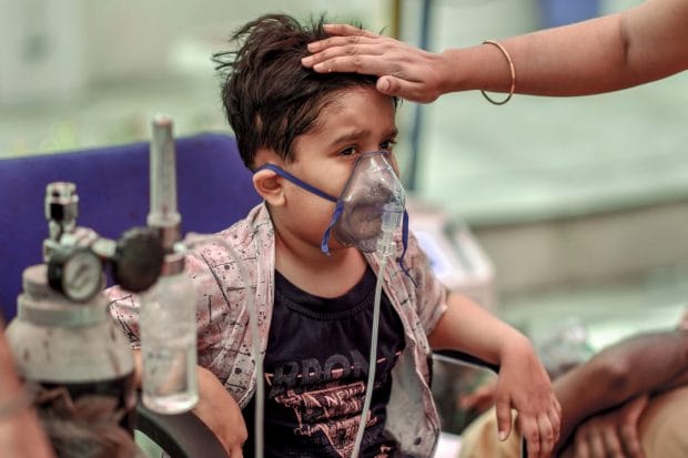 A COVID-19 positive child receives free oxygen provided by a Sikh organization, as coronavirus cases surge in record numbers across the country, at Indirapuram, Ghaziabad on May 5, 2021. (PTI Photo)