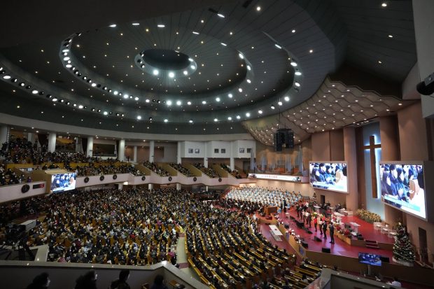 Christians on Saturday attended a Christmas service at the Yoido Full Gospel Church in Seoul, South Korea, while wearing face masks and maintaining social distancing. (Image: AP)