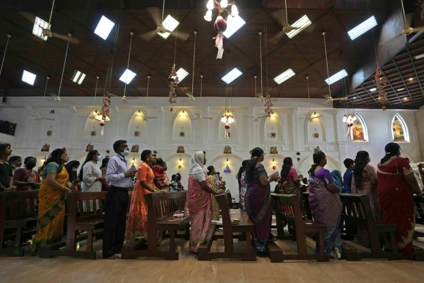 Sri Lankan devotees, mostly wearing face masks as a precaution against the COVID-19, attended a Christmas mass at a church in Colombo, Sri Lanka on Saturday. (Image: AP)