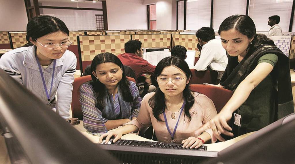 Ding Defen, a Chinese Infosys Technologies Ltd. employee, 2nd right, works with her INdian colleagues at her workstation in Electronic City, Bangalore, India December 22, 2005. China is courting Indian expertise and investment to help build its own software-services industry and reduce the influence of international giants such as International Business Machines Corp. and Hewlett-Packard Co. in its domestic market. Photographer: Namas Bhojani/Bloomberg News Ding Defen, a Chinese Infosys Technologies Ltd. employee, 2nd right, works with her INdian colleagues at her workstation in Electronic City, Bangalore, India December 22, 2005. China is courting Indian expertise and investment to help build its own software-services industry and reduce the influence of international giants such as International Business Machines Corp. and Hewlett-Packard Co. in its domestic market. Photographer: Namas Bhojani/Bloomberg News