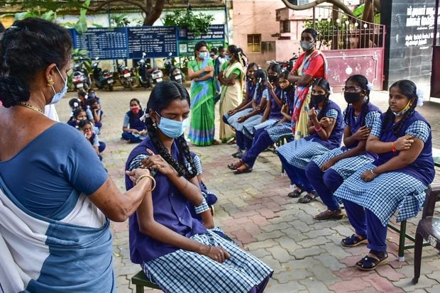 Madurai A health worker administers a COVID-19 vaccine to a teenager in Madurai. (PTI Photo)