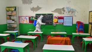 A worker sanitises a classroom at a school ahead of its reopening in Mumbai (Image: PTI)