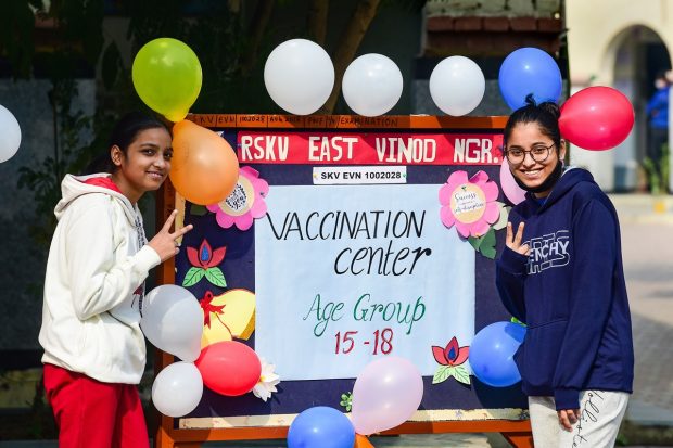 Students pose for photographs after being administered with a COVID-19 vaccine in New Delhi. (PTI Photo)
