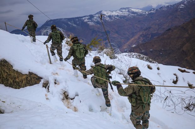 BSF personnel patrolling amid heavy snowfall in Jammu and Kashmir's Poonch district. (PTI Photo)