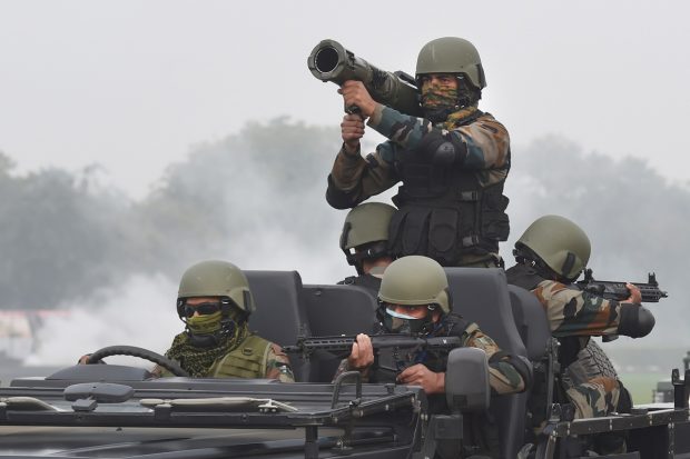 Army jawans display their war skills during the full dress rehearsal for the Army Day Parade, at Army Parade Ground in New Delhi. (PTI Photo)