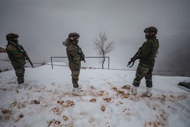 Amid heavy snowfall in Kashmir, Indian Army was seen patrolling at higher reaches in Poonch district. (PTI Photo)