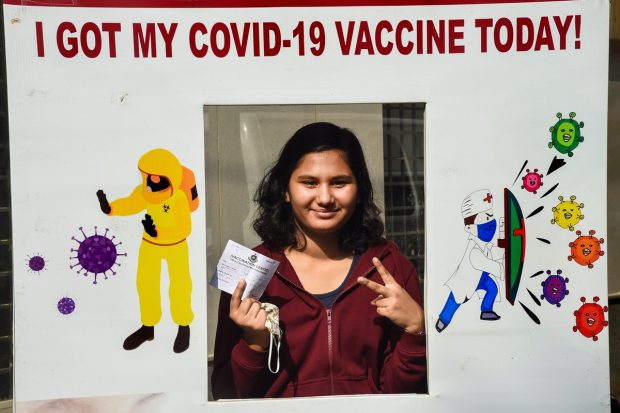 A teenager poses for a photograph after being administered a dose of COVID-19 vaccine during a inoculation drive for age group between 15 to 18 years, in New Delhi. (PTI Photo)