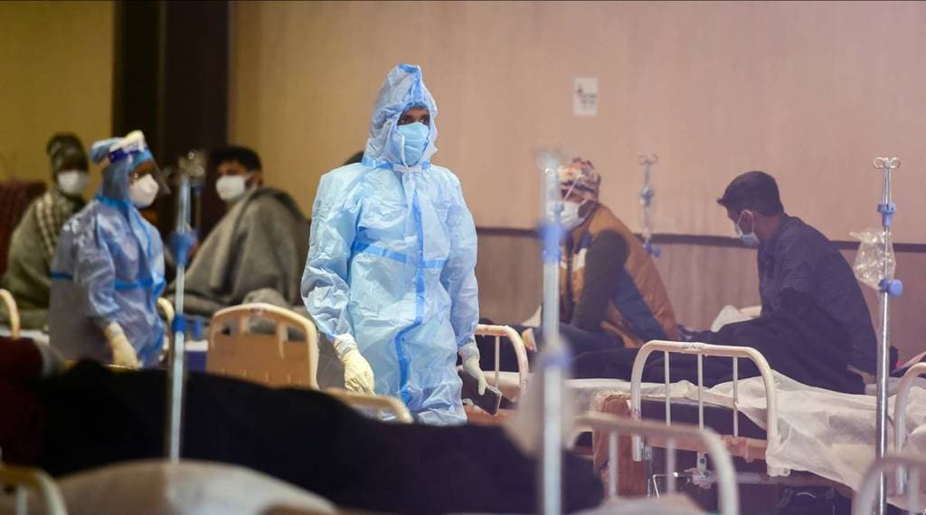 Covid-19 Omicron Variant Jan 16 highlights: A health worker interacts with Covid-19 patients inside the Shehnai Banquet Hall, a COVID-19 care facility, during the third wave of the coronavirus, in New Delhi. (PTI Photo)