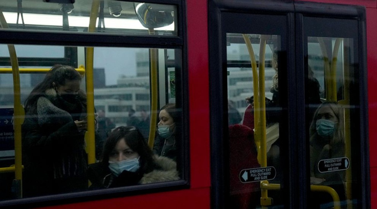 People wear face masks to curb the spread of coronavirus, which is still a mandatory requirement on Transport for London public transport services. (Photo source: AP) People wear face masks to curb the spread of coronavirus, which is still a mandatory requirement on Transport for London public transport services. (Photo source: AP)
