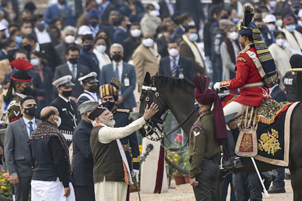 PM Narendra Modi caresses a horse of the President's Bodyguard, after the Republic Day Parade 2022, at Rajpath. President Ram Nath Kovind, Union Defence Minister Rajnath Singh are also seen. (PTI Photo)