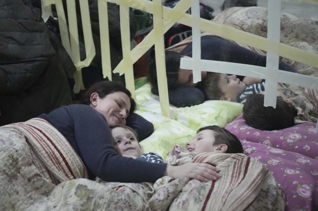 Mariupol: A woman and her children lie on the floor in the improvised bomb shelter in a sports center, which can accommodate up to 2000 people, in Mariupol, Ukraine. Explosions and gunfire that have disrupted life since the invasion began last week appeared to subside around Kyiv overnight, as Ukrainian and Russian delegations prepared to meet on February 28, 2022 on Ukraine's border with Belarus. It's unclear what, if anything, those talks would yield. Terrified Ukrainian families huddled in shelters, basements or corridors, waiting to find out. (AP Photo)