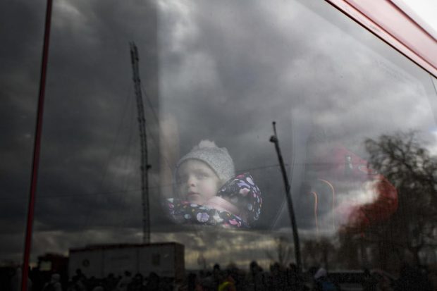 Siret: A refugee child fleeing the conflict from neighbouring Ukraine sits in a bus at the Romanian-Ukrainian border, in Siret, Romania. The European Union's commissioner for home affairs Ylva Johansson visited Romania's northern border crossing in Siret Monday where thousands of refugees are entering from neighboring Ukraine as they flee the conflict with Russia. (AP Photo)