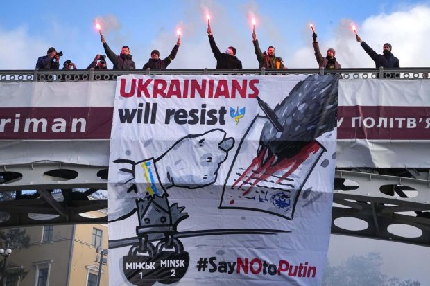 Ukrainians attend a rally in central Kyiv, Ukraine, during a protest against the potential escalation of the tension between Russia and Ukraine. (AP Photo)