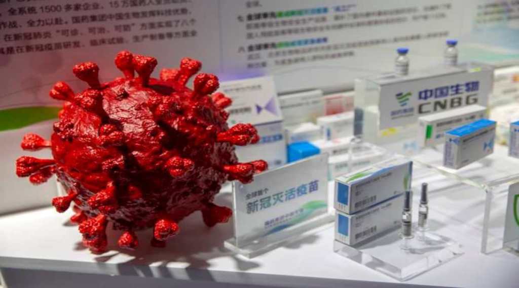 A model of a coronavirus is displayed next to boxes for COVID-19 vaccines at an exhibit by Chinese pharmaceutical firm Sinopharm at the China International Fair for Trade in Services (CIFTIS) in Beijing, Saturday, Sept. 5, 2020. (AP Photo/Mark Schiefelbein)
