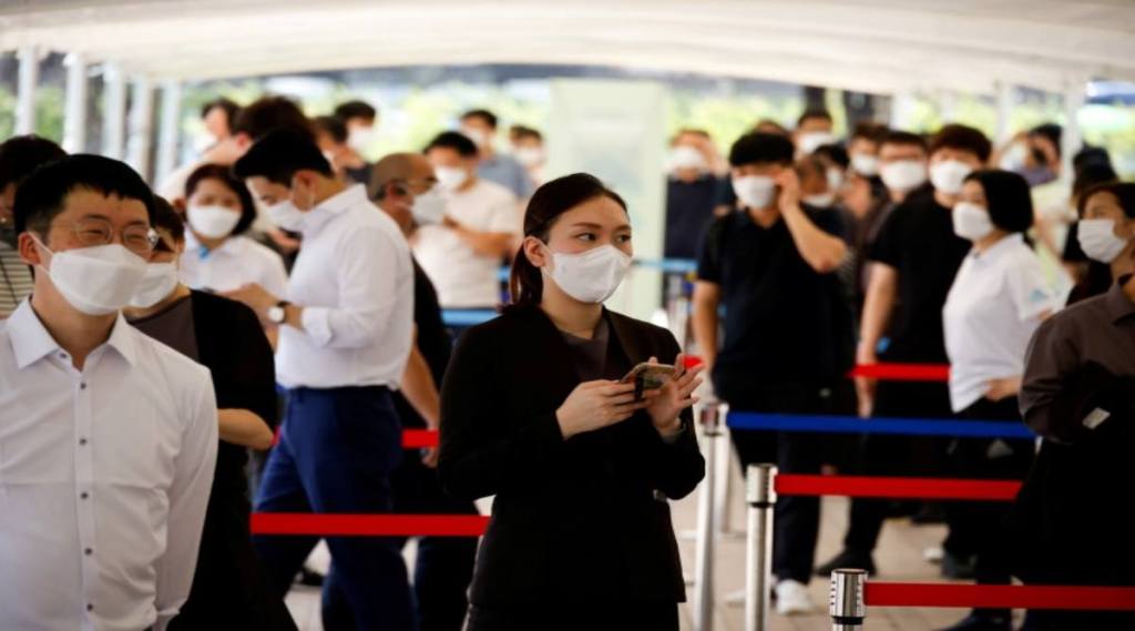 FILE PHOTO: People wait in line to get coronavirus disease (COVID-19) test at a coronavirus testing site in Seoul, South Korea, July 15, 2021. REUTERS/Kim Hong-Ji