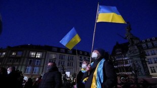 People hold Ukrainian flags (Reuters image)