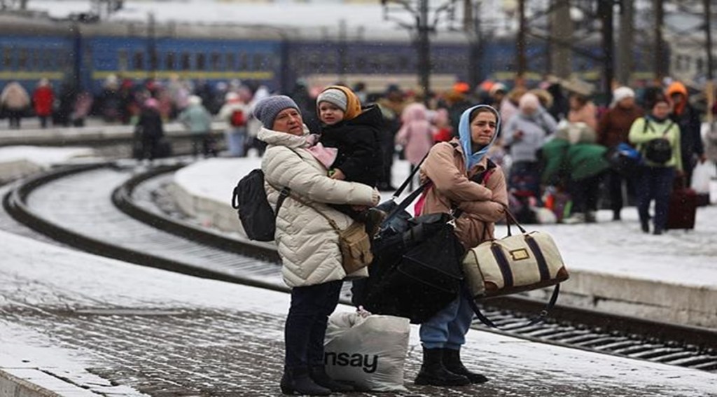 People wait for a train heading to Poland as they flee Russia's invasion of Ukraine, in the train station in Lviv, Ukrain. (Reuters image)