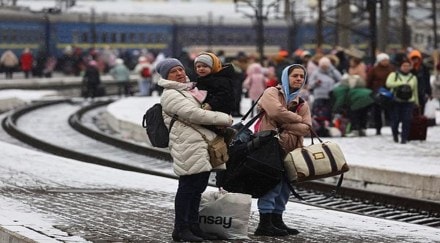People wait for a train heading to Poland as they flee Russia's invasion of Ukraine, in the train station in Lviv, Ukrain. (Reuters image)