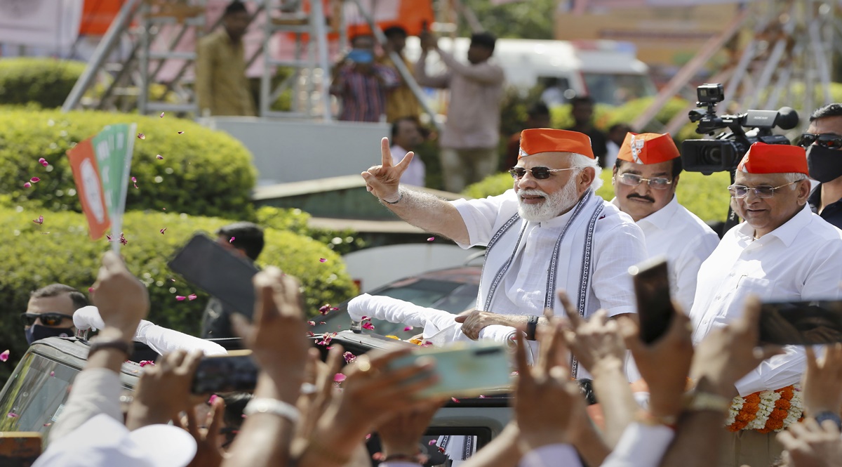 Prime Minister Narendra Modi flashes the victory sign during a roadshow in Ahmedabad on Friday. Gujarat chief minister Bhupendra Patel and state BJP president CR Patil (centre) are also seen. Prime Minister Narendra Modi flashes the victory sign during a roadshow in Ahmedabad on Friday. Gujarat chief minister Bhupendra Patel and state BJP president CR Patil (centre) are also seen.