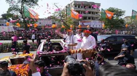 Prime Minister Narendra Modi waves during a road show in Ahmedabad (AP Image)