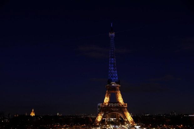 The Eiffel Tower is lit up in blue and yellow, the colours of the Ukrainian flag, in support of the Ukrainian people after Russia launched a massive military operation against Ukraine, in Paris, France. (Reuters Photo)