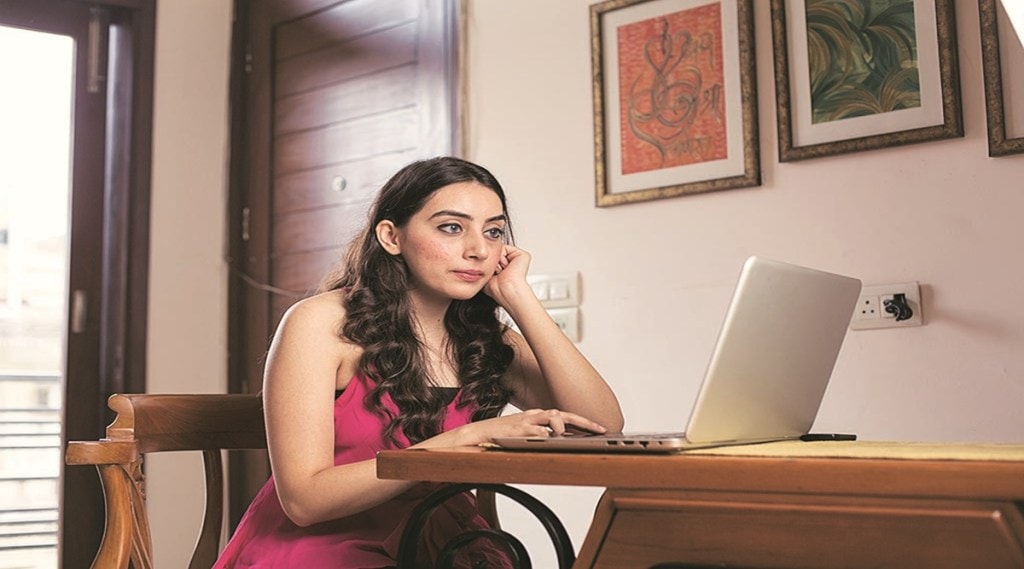 Young woman working on laptop at home
