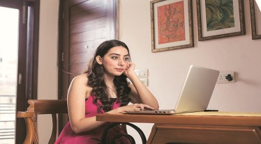 Young woman working on laptop at home