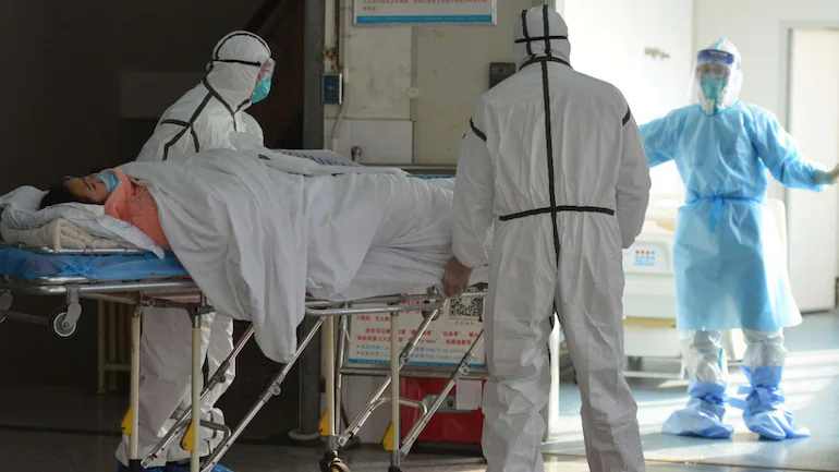 Medical workers move a patient to an isolation ward in China's Anhui Province. (AP)
