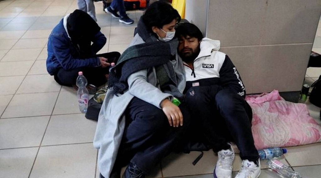 Indian students rest at teh floor of a train station after fleeing Ukraine (Reuters image)