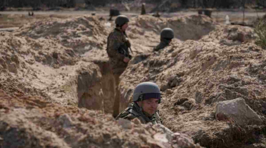 Ukrainian servicemen stand in trenches at a position north of the capital Kyiv, Ukraine, Tuesday, March 29, 2022. The first face-to-face talks in two weeks between Russia and Ukraine began Tuesday in Turkey, raising flickering hopes there could be progress toward ending a war that has ground into a bloody campaign of attrition. (AP Photo/Vadim Ghirda)