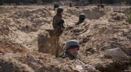 Ukrainian servicemen stand in trenches at a position north of the capital Kyiv, Ukraine, Tuesday, March 29, 2022. The first face-to-face talks in two weeks between Russia and Ukraine began Tuesday in Turkey, raising flickering hopes there could be progress toward ending a war that has ground into a bloody campaign of attrition. (AP Photo/Vadim Ghirda)