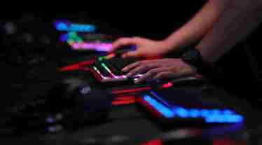 A gamer uses an illuminated keyboard to play a computer game at the Gamescom gaming industry event in Cologne, Germany, on Tuesday, Aug. 21, 2018. (Photographer: Krisztian Bocsi/Bloomberg)
